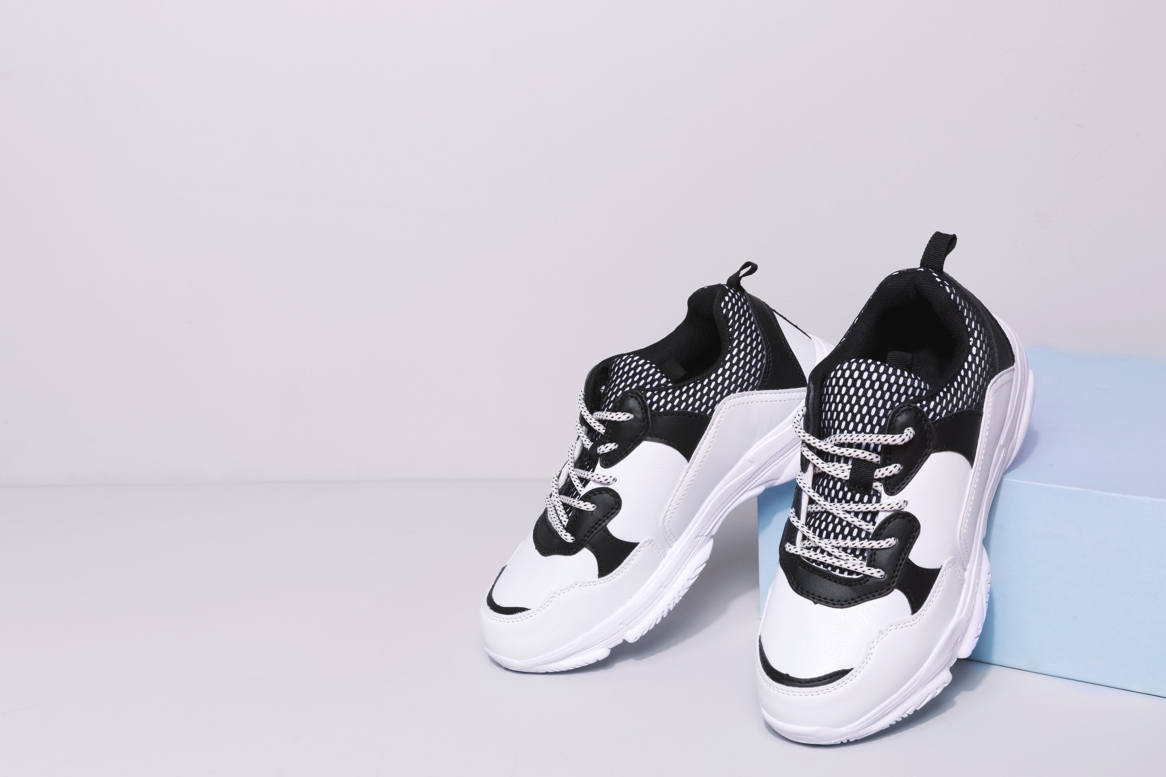 Black and white sneakers on a light gray background